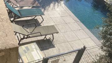 Seasonal outdoor pool, open 9:00 AM to 8:00 PM, pool umbrellas