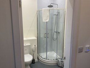 A modern bathroom with a glass-enclosed shower, a toilet, and a bidet. - Claremont Hotel (Preston)