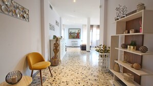 A modern interior with a yellow chair, a white bookshelf, and a mosaic floor. - Wonderful  villa for 6 people with WIFI, TV, terrace and panoramic view, close to Forte Dei Marmi (Marina Dei Ronchi)
