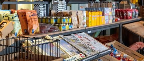 A grocery store with various food items on shelves and in bins.