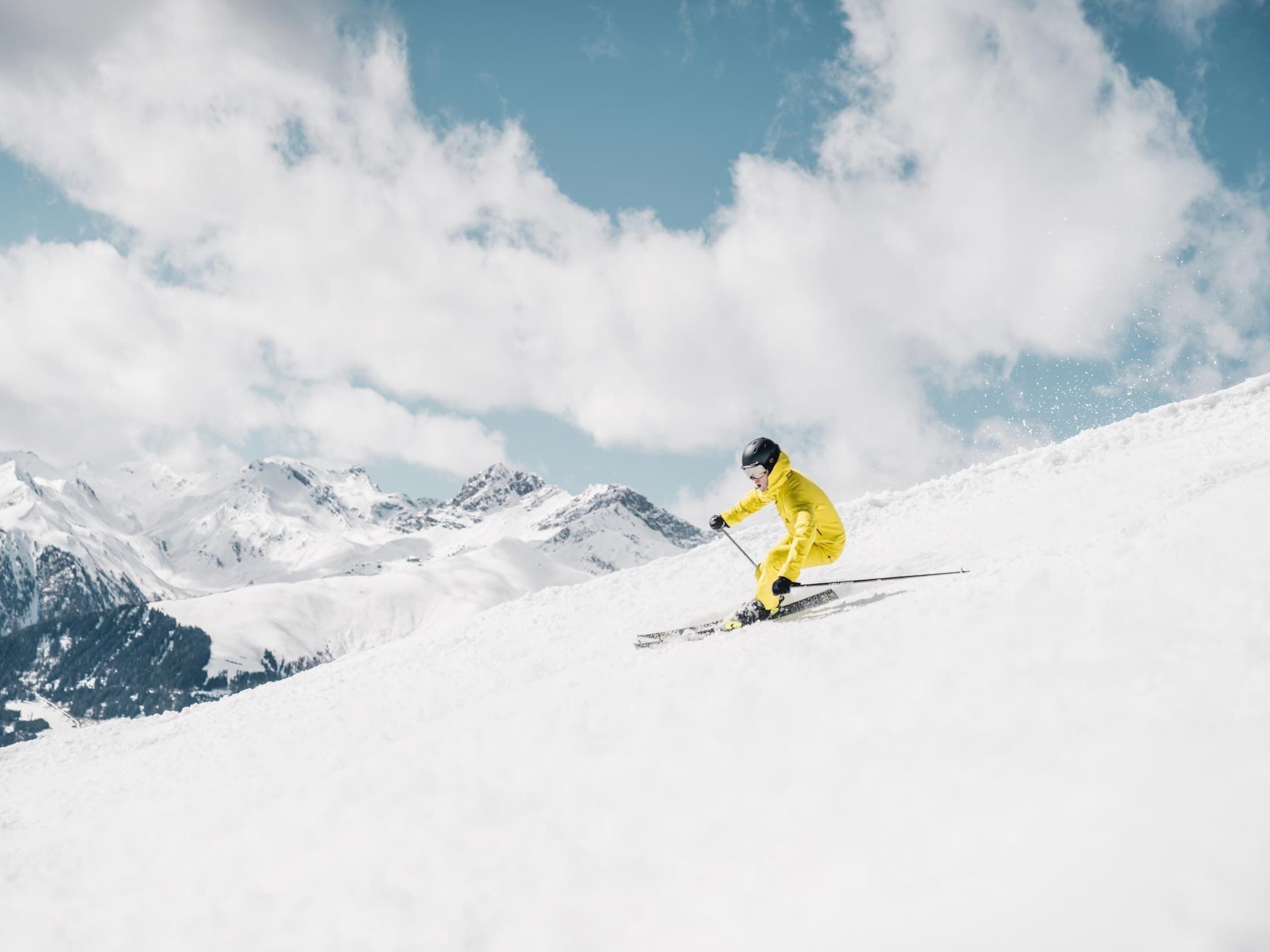 A person skiing on a snowy mountain slope.