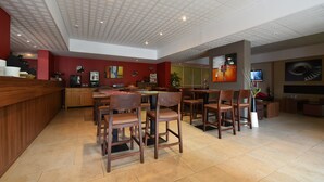 A spacious dining area with wooden furniture, a bar counter, and a television screen. - Chalet in Isola Near Ski Slopes (Isola)