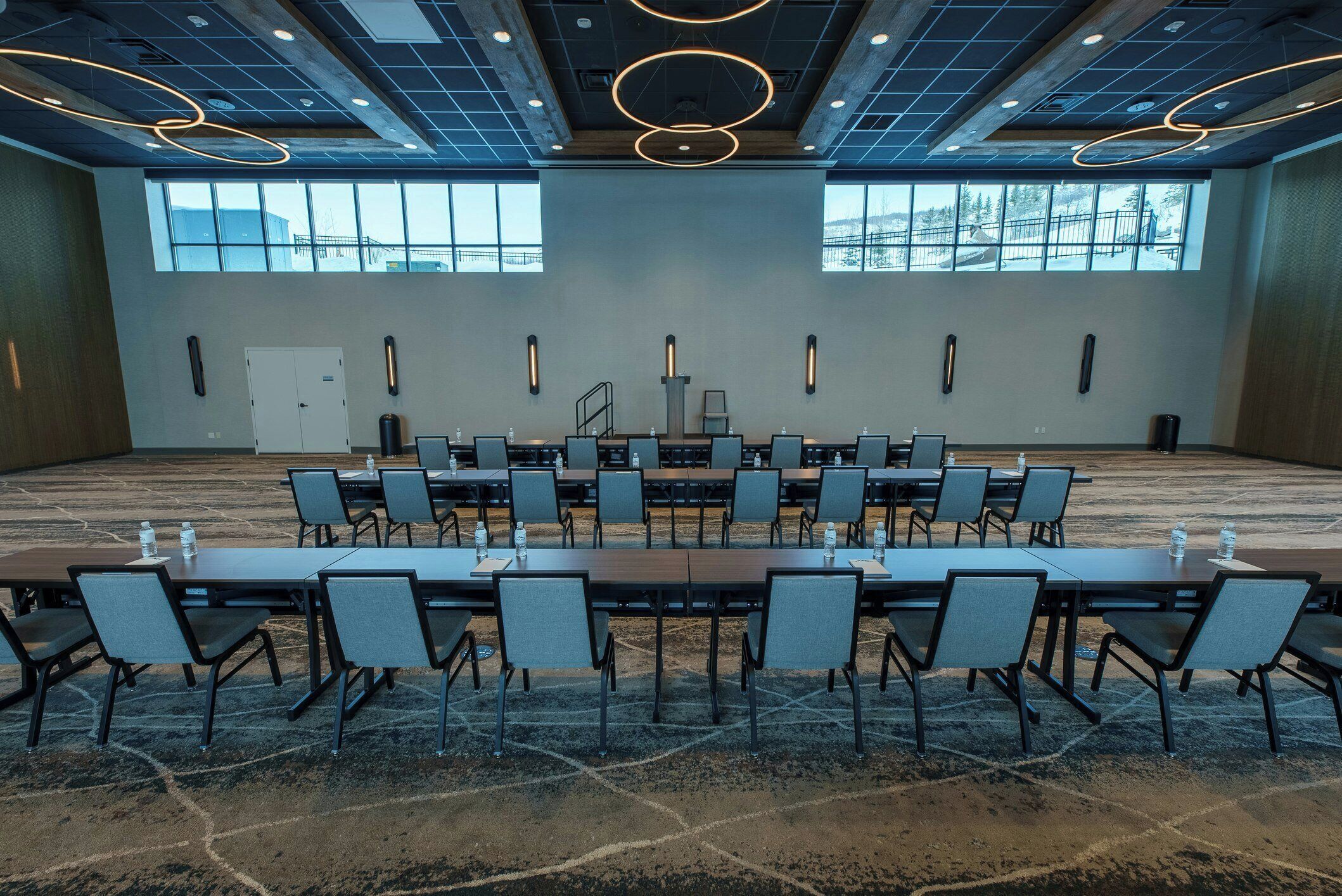 A conference room with a long table, chairs, and a fireplace.