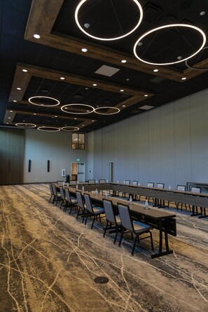 A conference room with a long table, chairs, and a patterned carpet. - Black Rock Mountain Resort (Heber City)