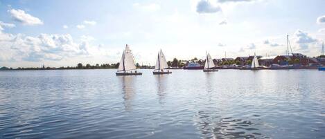 A calm lake with sailboats.