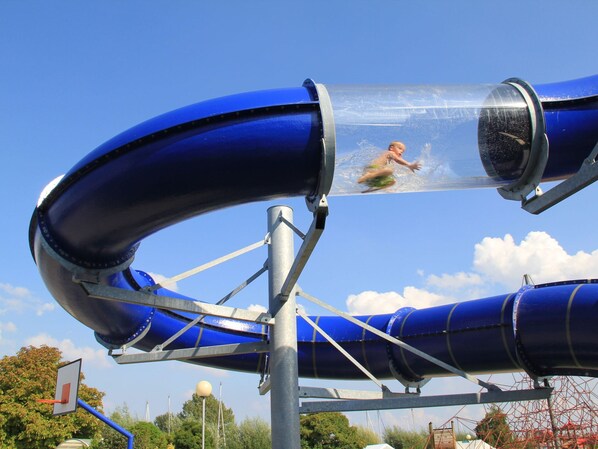 A water slide with a clear water tube and a metal structure. - Spacious House in Netherlands for 8 Guests (Kortgene)
