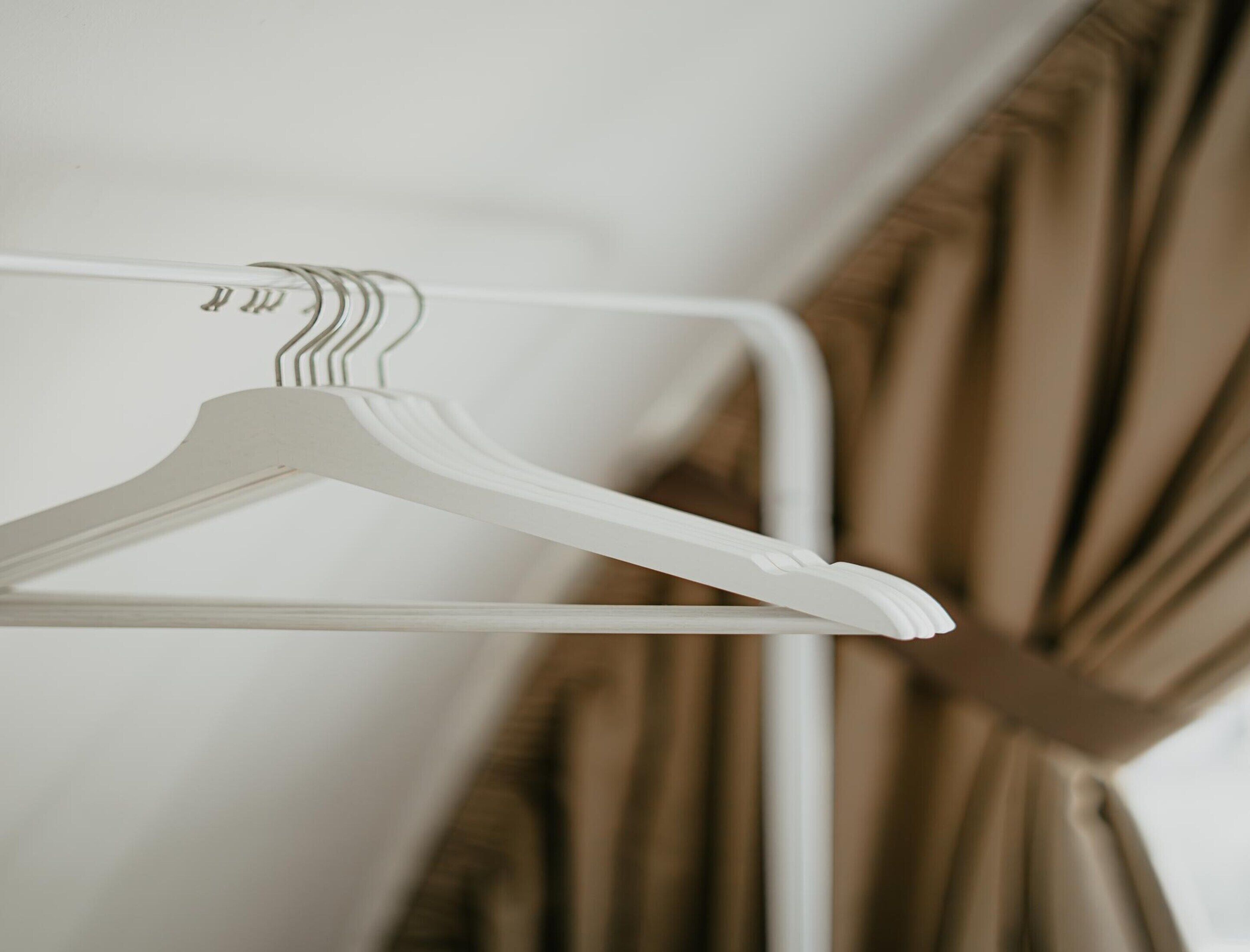 A white metal hanger on a white metal rack.