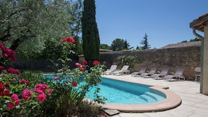 A swimming pool with lounge chairs, surrounded by stone walls and greenery. - Mansion in Fournes With Private Pool (Fournes)
