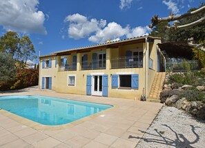 A two-story building with a swimming pool, a balcony, and a staircase leading to a covered area. - Villa in Vidauban With Private Pool (Vidauban)
