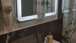 A bathroom with a hairdryer, a mirror, and a soap dispenser. - Apartment in Oetz Near Ski Lift (Oetz)