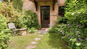 A stone building with a wooden door, a bench, and a sign reading 'La Maison.' - Holiday Home in Dordogne Near Lascaux Cave (Les Eyzies)