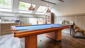 A pool table in a room with a wooden ceiling, a cabinet, and a decorative horse statue. - Secluded Farmhouse in Balkbrug with Hot Tub (Balkbrug)