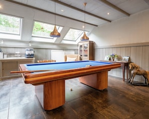 A pool table in a room with a wooden ceiling, a cabinet, and a decorative horse statue. - Secluded Farmhouse in Balkbrug with Hot Tub (Balkbrug)
