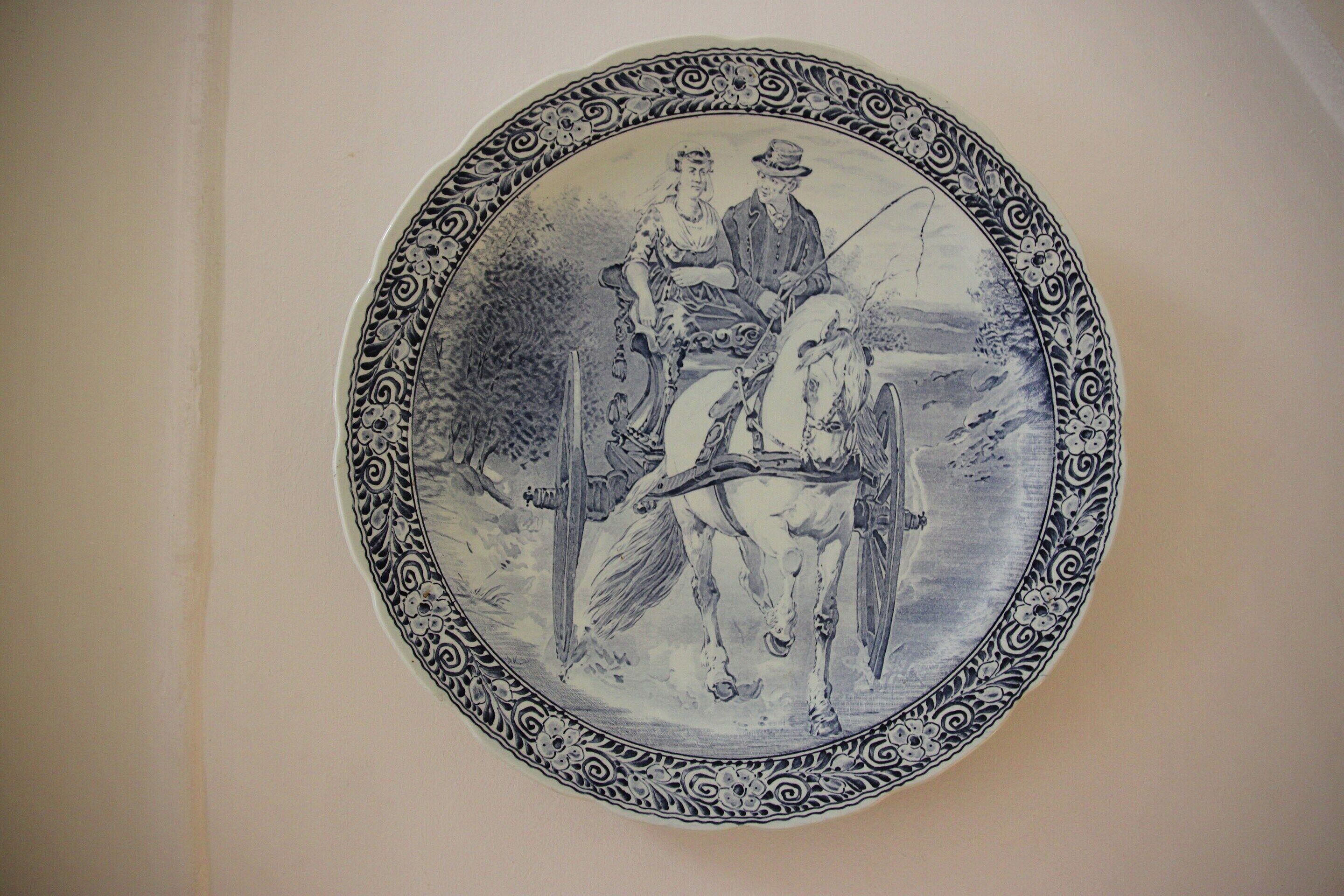 A decorative plate with a horse and rider.