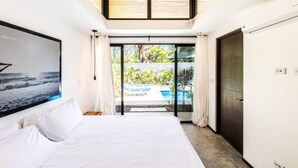 A bedroom with a large bed, a view of a swimming pool, and a sliding glass door leading to an outdoor area. - Flow - Casita, For Love Of Waves (Nosara)