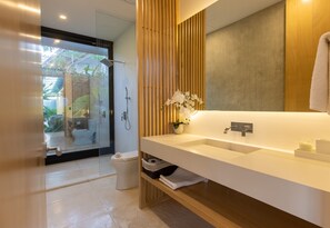 A modern bathroom with a glass-enclosed shower, a wooden vanity, and a large mirror. - Nai'a, Chef Included | Gated Comunity (Nosara)