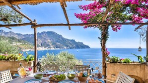 A table set for a meal with a view of the sea and mountains. - Star Fish House - Two Bedroom Villa, Sleeps 5 (San Cosma)