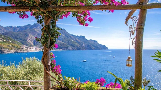 A wooden pergola with pink bougainvillea flowers and a lantern, overlooking a coastal view with mountains and the sea. - Star Fish House - Two Bedroom Villa, Sleeps 5 (San Cosma)