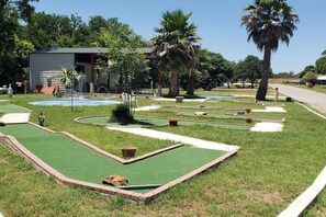 Play a round of golf amidst lush greenery and serene surroundings.