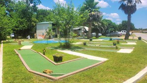 A miniature golf course with a green field, sand traps, and a small pond. - **LakeViewCondo! Boat Slip Included! Steps2Lake** (Kingsland)