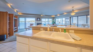 A spacious kitchen with a large island, a double sink, and ample natural light from large windows. - Falls 118 - 4 Bdrm condo with Breathtaking View (Lake Ozark)
