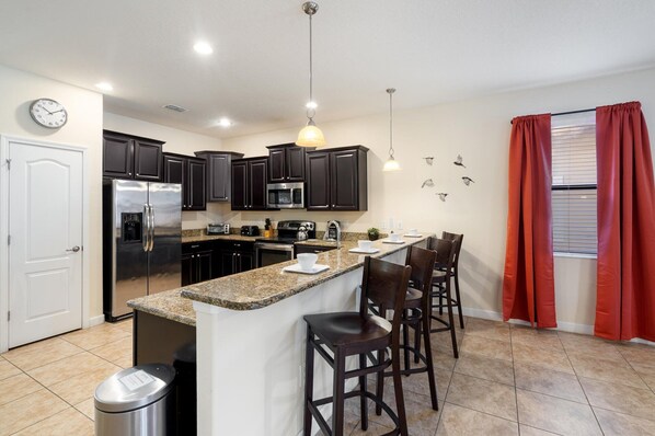 Fridge, microwave, oven, stovetop - Championsgate Resort 8 Bedroom Private Pool Home (Davenport)