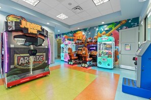 Play classic arcade games in this vibrant entertainment space featuring claw machines and interactive games.