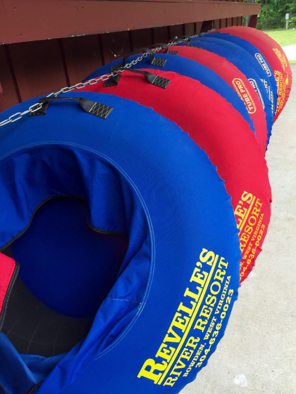 A row of blue and red floating tubes with "Revelle's River Resort" branding.
