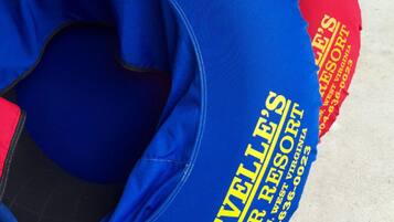 A row of blue and red floating tubes with "Revelle's River Resort" branding.
