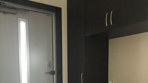 A room with a door, a dark wooden cabinet, and a tiled floor. - Villa Paolo (Furano)