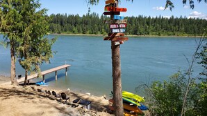 A wooden signpost with multiple directional signs pointing to various locations.