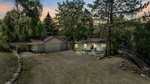 A residential property with a detached garage, a covered patio, and a fenced yard.