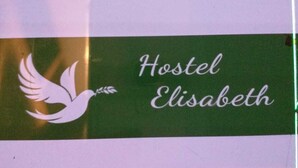 A sticker on a surface with the text "Hostel Elisabeth" and a white dove graphic. - Ferienwohnung) (Wien)