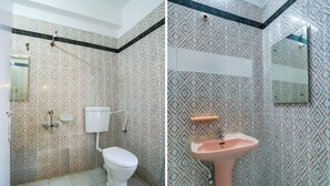 A bathroom with patterned tiles, a toilet, a sink, and a mirror. - OYO 49253 Raja Residency (Hyderabad)