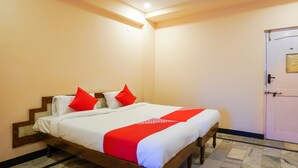 A hotel room with a bed, a door, and a tiled floor. - OYO 49253 Raja Residency (Hyderabad)