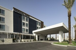 A modern hotel with a large sign reading "SPRINGHILL SUITES." - SpringHill Suites by Marriott Phoenix Goodyear (Goodyear)