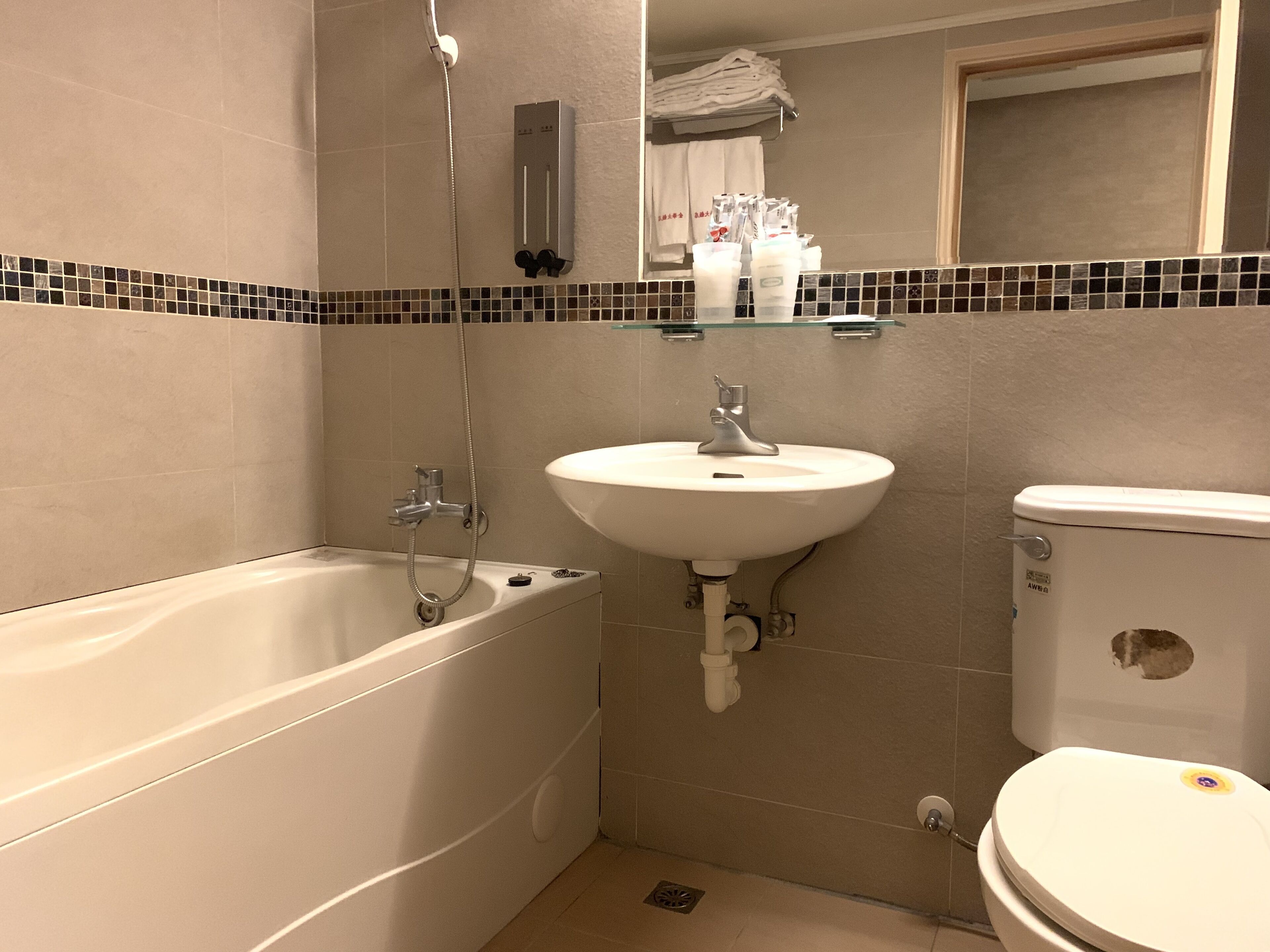 A bathroom with a bathtub, sink, and toilet.