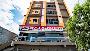 A multi-story hotel with a signboard advertising amenities like a market hall, A/C room, sweets, and dry fruits. - OYO 63209 Hotel Ram Ratan Grand (Hyderabad)