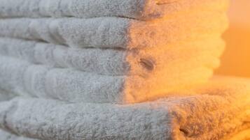 A stack of white towels with a textured pattern.
