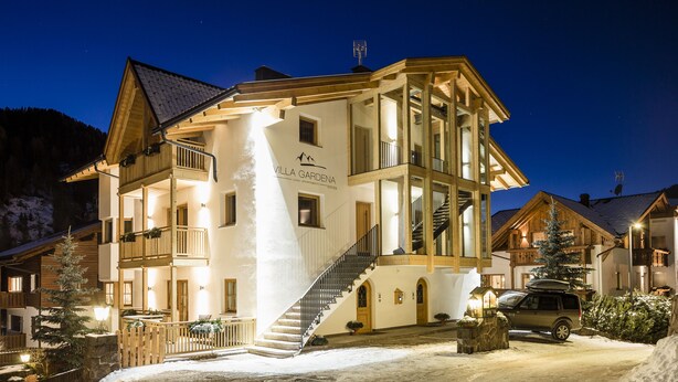 A multi-story hotel with a prominent staircase, balconies, and a sign reading "VILLA GARDENA".