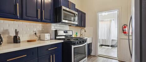 Fridge, stovetop, dishwasher, coffee/tea maker
