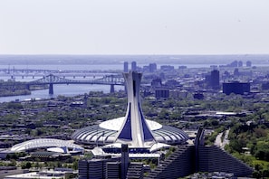 A modern architectural structure with a central tower and surrounding buildings, likely a hotel or conference center. - Hilton Garden Inn Montreal Midtown (Montreal)
