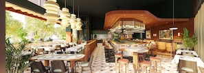 A restaurant with multiple dining areas, a bar, and a view of greenery outside. - Hilton Garden Inn Montreal Midtown (Montreal)