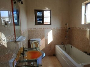 Combined shower/bathtub, towels, soap, toilet paper