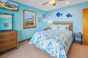 A bedroom with a bed, dresser, and a ceiling fan. - Soundfront Dog Friendly Home w/ Hot Tub, Game Room, Private Boat Dock, Kayaks (Avon)