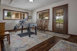 Enjoy a game of foosball in the hallway, surrounded by a large window offering a view of the outside and a decorative door.