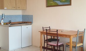 Fridge, electric kettle, dining tables