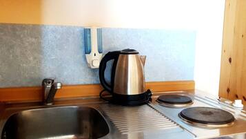 Fridge, electric kettle, dining tables