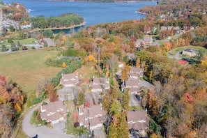 A residential area with houses, a lake, and autumn foliage. - Spacious 5BR Retreat w/ Ping Pong & Fire Pit (Oakland)