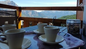 A table with cups and saucers on a balcony overlooking a mountainous landscape. - SOUTH ALPES APARTMENT PUY SAINT VINCENT 1800 M Ski resort summer / winter (Puy-Saint-Vincent)